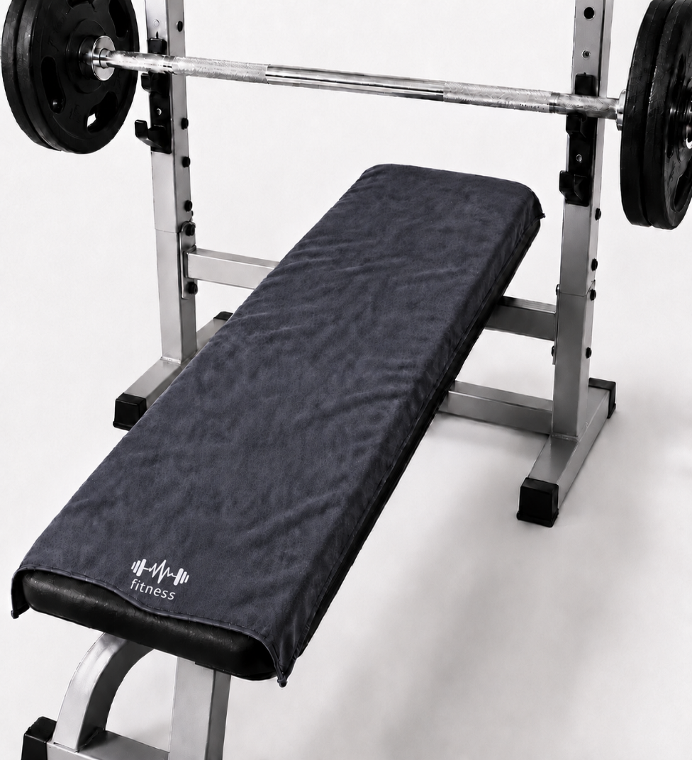 Grey STRIVEX gym towel placed over a workout bench